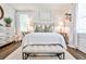 Bright bedroom featuring a bench, white bedding and minimalist decor at 68 Peachtree Memorial Nw Dr # 68-5, Atlanta, GA 30309