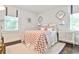 Bedroom featuring white walls, a floral comforter, windows, and decorative lighting at 68 Peachtree Memorial Nw Dr # 68-5, Atlanta, GA 30309