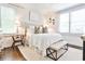 Bright bedroom featuring a tufted headboard, bench, white bedding and plenty of natural light at 68 Peachtree Memorial Nw Dr # 68-5, Atlanta, GA 30309