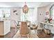 Bright dining area with a stylish chandelier, a round table, and views of the outdoors at 68 Peachtree Memorial Nw Dr # 68-5, Atlanta, GA 30309