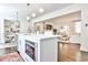 Open concept kitchen with a central island, stainless steel oven, and a seamless view into the living room at 68 Peachtree Memorial Nw Dr # 68-5, Atlanta, GA 30309