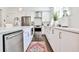Contemporary kitchen featuring stainless steel appliances, white cabinetry, and a spacious countertop at 68 Peachtree Memorial Nw Dr # 68-5, Atlanta, GA 30309