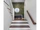 Staircase featuring white stairs, a wooden railing and a green accent wall at 68 Peachtree Memorial Nw Dr # 68-5, Atlanta, GA 30309