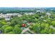 Aerial view of a house nestled among trees, with a cityscape in the distance at 727 Holmes Nw St, Atlanta, GA 30318