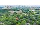 Aerial view of home surrounded by beautiful trees with a cityscape view in the background at 727 Holmes Nw St, Atlanta, GA 30318