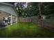 Backyard with a patio, privacy fence, lush greenery, and string lights at 727 Holmes Nw St, Atlanta, GA 30318