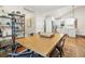 View of dining room leading to kitchen with wood floors and contemporary finishes at 727 Holmes Nw St, Atlanta, GA 30318