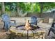 Stone firepit with Adirondack chairs, nestled in a wooded backyard at 727 Holmes Nw St, Atlanta, GA 30318