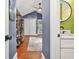 Hallway leading to full bathroom with a ceiling fan and hardwood flooring at 727 Holmes Nw St, Atlanta, GA 30318
