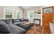 Cozy living room area featuring a plush gray sectional and a view of the front entrance at 727 Holmes Nw St, Atlanta, GA 30318