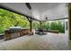 Outdoor kitchen featuring stone accents, a built-in grill, and an adjacent dining area for al fresco meals at 1525 Lockridge Dr, Cumming, GA 30041