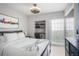 Bright bedroom featuring a cozy bed, built-in desk, and sliding glass doors leading to a private balcony at 199 14Th Street Ne St # 2501, Atlanta, GA 30309