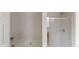Bathroom showcasing the bathtub and glass shower stall at 2320 Polaris Sw Way, Atlanta, GA 30331