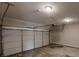 White garage door is closed in this unfinished garage at 2320 Polaris Sw Way, Atlanta, GA 30331