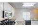 Modern kitchen with stainless steel appliances and bright white cabinetry at 2320 Polaris Sw Way, Atlanta, GA 30331