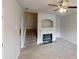 Cozy living room featuring a fireplace, ceiling fan, and staircase at 2320 Polaris Sw Way, Atlanta, GA 30331