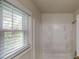 Bathroom featuring a shower, and window with blinds, creating a calming and bright atmosphere at 3136 Palomino Dr, Powder Springs, GA 30127