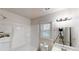 Bright bathroom features shower, tub, vanity and window at 3136 Palomino Dr, Powder Springs, GA 30127