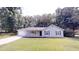 Charming single-story home featuring a well-manicured lawn and a welcoming front porch at 3136 Palomino Dr, Powder Springs, GA 30127