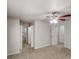 Spacious primary bedroom features neutral walls, carpet, ceiling fan and multiple doors at 3136 Palomino Dr, Powder Springs, GA 30127