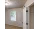 Cozy bedroom with neutral carpet, a textured ceiling, and natural light from the window at 3457 Newberry Trl, Decatur, GA 30034