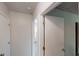 Hallway with white walls, white doors, and an open doorway leads into another room at 3457 Newberry Trl, Decatur, GA 30034