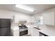 Modern kitchen featuring stainless steel appliances, white cabinets, and ample counter space at 3457 Newberry Trl, Decatur, GA 30034