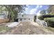 View of backyard featuring a two-story home with a white staircase to the second level at 3695 Fox Hills Se Dr, Marietta, GA 30067