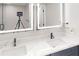 Bathroom showing the quartz countertop, double sinks, and lighted mirrors at 3695 Fox Hills Se Dr, Marietta, GA 30067
