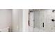 Modern bathroom boasts frameless glass shower, marble floors and patterned accent wall at 3695 Fox Hills Se Dr, Marietta, GA 30067