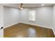Spacious bedroom features hardwood floors, a ceiling fan, and natural lighting at 3695 Fox Hills Se Dr, Marietta, GA 30067