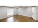 This primary bedroom has hardwood floors, a window, and a ceiling fan at 3695 Fox Hills Se Dr, Marietta, GA 30067