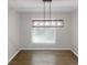 Dining room with hardwood floors and a modern chandelier hanging over the dining space at 3695 Fox Hills Se Dr, Marietta, GA 30067