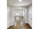 Inviting hallway showcasing dark wood floors and an entryway leading to a bright living area at 3695 Fox Hills Se Dr, Marietta, GA 30067