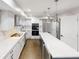 Contemporary kitchen featuring white cabinets, quartz countertops, stainless appliances, and an island with seating at 3695 Fox Hills Se Dr, Marietta, GA 30067