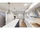 Modern kitchen with white countertops and stainless steel appliances; open view into the living area at 3695 Fox Hills Se Dr, Marietta, GA 30067