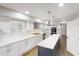 Bright kitchen features white cabinets, modern appliances, and a center island with counter seating at 3695 Fox Hills Se Dr, Marietta, GA 30067