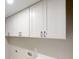Bright laundry room with white cabinets and black hardware above the counters at 3695 Fox Hills Se Dr, Marietta, GA 30067