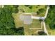 Aerial view of the property with a long driveway and well-maintained yard, surrounded by trees at 90 Mckown Rd, Fayetteville, GA 30214