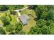 Aerial view of the home surrounded by trees and a long driveway at 90 Mckown Rd, Fayetteville, GA 30214