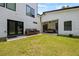 Relaxing backyard features lush grass, patio with swing, seating, and modern exterior at 90 Mckown Rd, Fayetteville, GA 30214