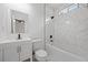 Bathroom featuring a shower-tub combo with white marble-style tiling, a modern white vanity, and dark fixtures at 90 Mckown Rd, Fayetteville, GA 30214