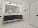 Modern bathroom with floating double vanity, illuminated mirror, and sleek fixtures at 90 Mckown Rd, Fayetteville, GA 30214