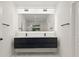 Modern bathroom features a double sink vanity with a large, illuminated mirror and sleek, minimalist fixtures at 90 Mckown Rd, Fayetteville, GA 30214