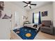 Cozy bedroom with hardwood floors, a twin bed with space-themed bedding, and a comfortable armchair at 90 Mckown Rd, Fayetteville, GA 30214