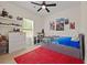 Bright bedroom featuring a red rug, a trundle bed, and plenty of storage space for toys and books at 90 Mckown Rd, Fayetteville, GA 30214