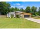 Stunning modern home with a well-manicured lawn and stylish architectural design at 90 Mckown Rd, Fayetteville, GA 30214