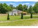 Modern home with sleek lines, lush landscaping, and a well-manicured front yard at 90 Mckown Rd, Fayetteville, GA 30214