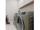 Clean laundry room equipped with modern washer and dryer units and storage cabinets at 90 Mckown Rd, Fayetteville, GA 30214