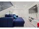 Modern living room featuring a plush blue sectional sofa and a large-screen television at 90 Mckown Rd, Fayetteville, GA 30214